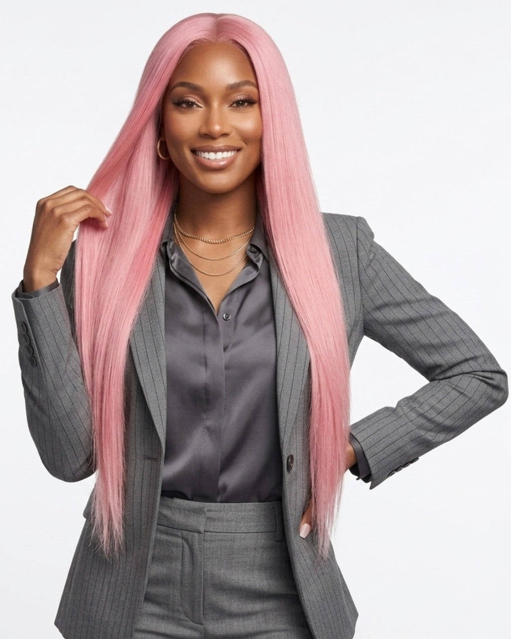 Woman with pink hair wearing a gray suit on a white background