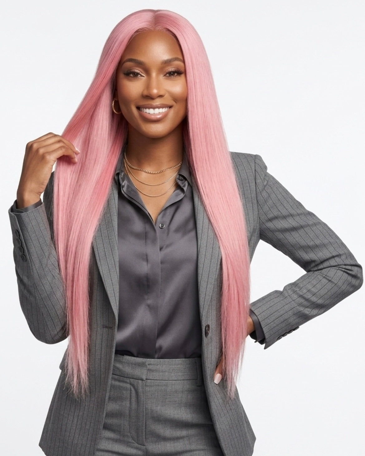 Woman with pink hair wearing a gray suit on a white background