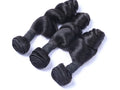 Three bundles of black hair extensions on a white background